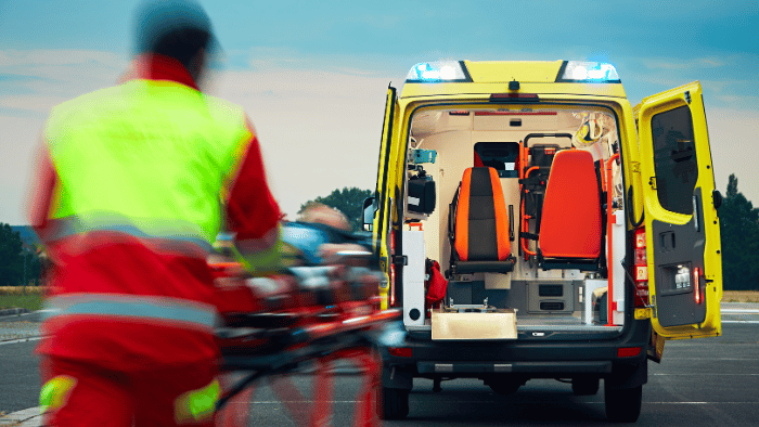 Emergency team taking the injured inside the ambulance
