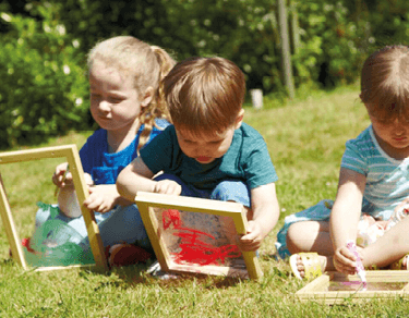 Toddlers playing with toys outdoors