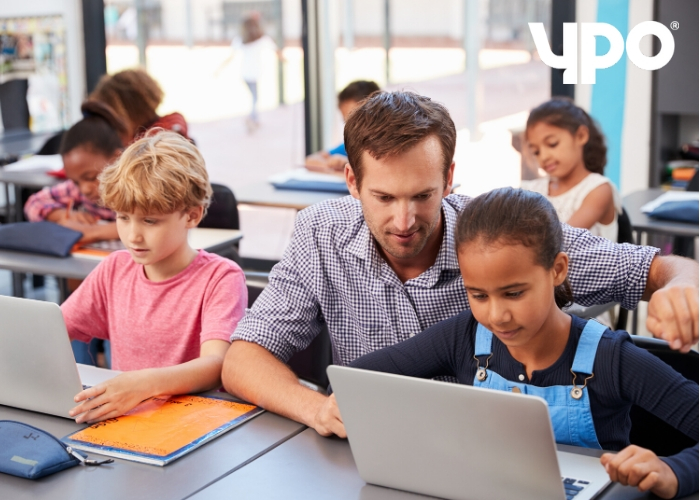 teach and students using laptops in classroom