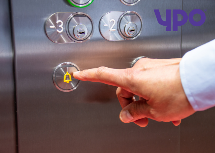 Male pressing alarm button in lift