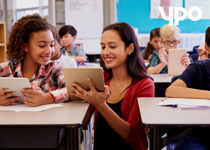 students and teacher using tablets