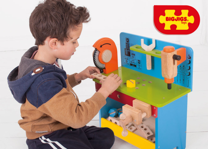Boy role playing with toy mechanical tools